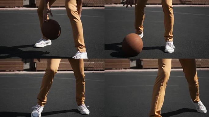 在橡胶涂层篮球场上运球，橙色球的家伙，黄色裤子白色运动鞋