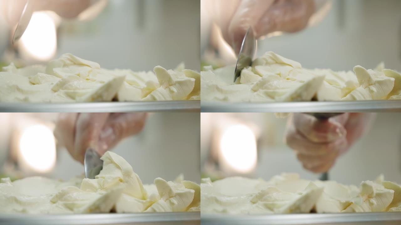 奶油奶酪的铺展拿起勺子。关闭慢动作