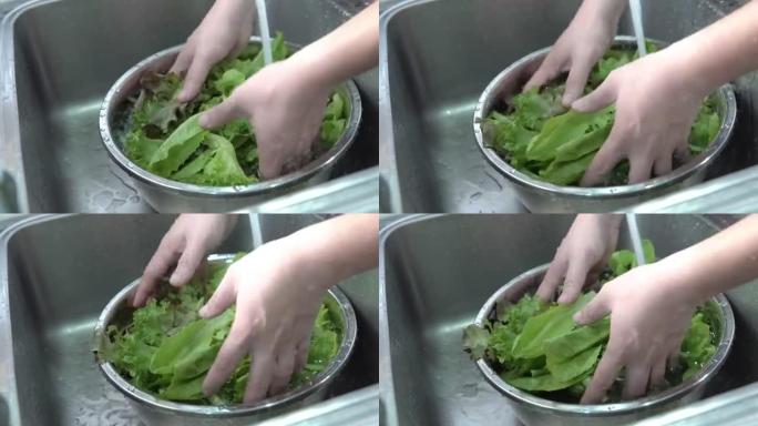 男人洗手沙拉。沙拉制作洗菜清水
