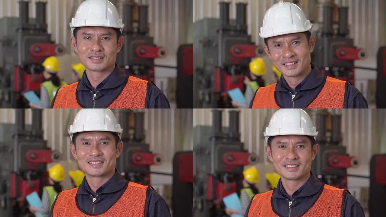 自信的亚洲男子工程师工业领班站着微笑的肖像。穿着安全制服的技术员。工业技术制造厂。