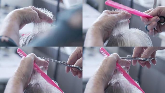 专业护理员造型师剪下高级女性灰白头发的特写手持镜头
