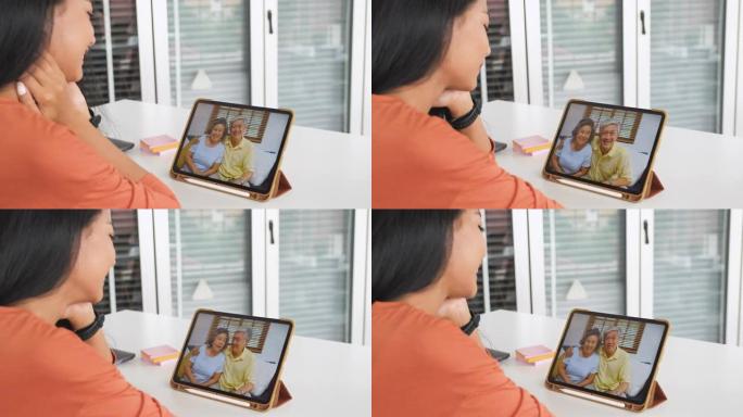 亚洲女儿与祖父母用数字平板电脑进行视频通话，在家中获得幸福。社交距离与新的正常交流生活方式
