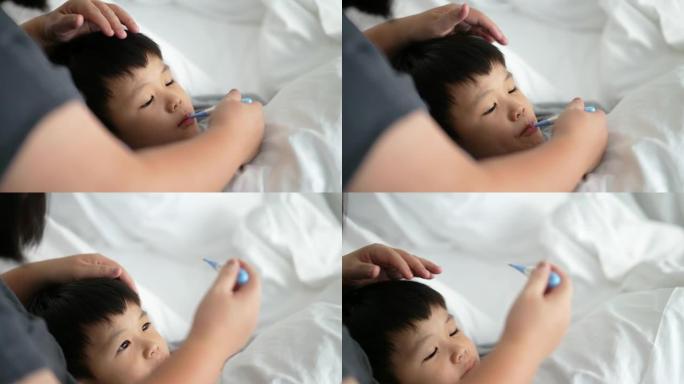 亚洲孩子对体温计和母亲感到恶心。照顾和生病的概念