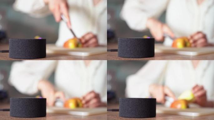 烹饪语音食谱。智能厨房有助于烹饪。手中的一把刀在背景中切苹果4k