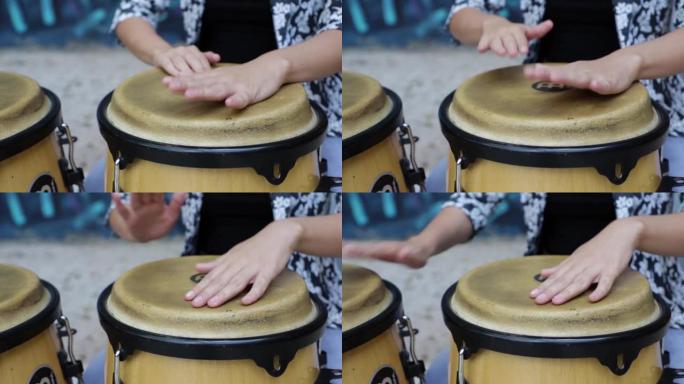 女性打击乐手演奏tummadora鼓。她双手的特写。