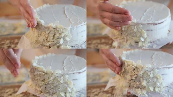一位女糕点师准备蛋糕，并用杏仁片装饰。制作酥饼的各个阶段esterhazy特写。