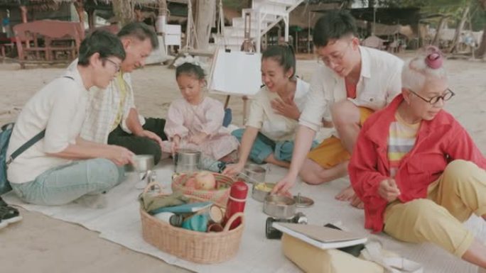 与大家庭一起在海滩上野餐的新体验-股票视频