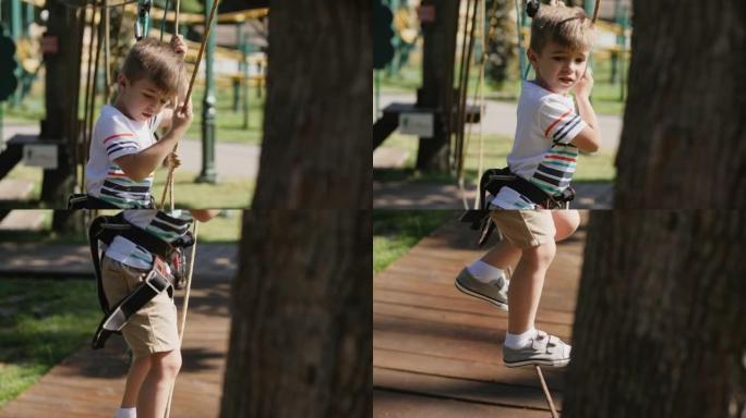 小男孩沿着树之间的绳索移动，特写