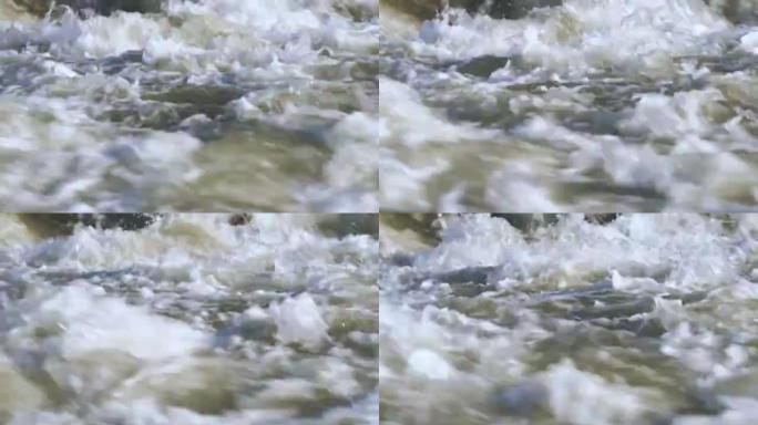 特写细节，晴天河流中的水流形成白浪