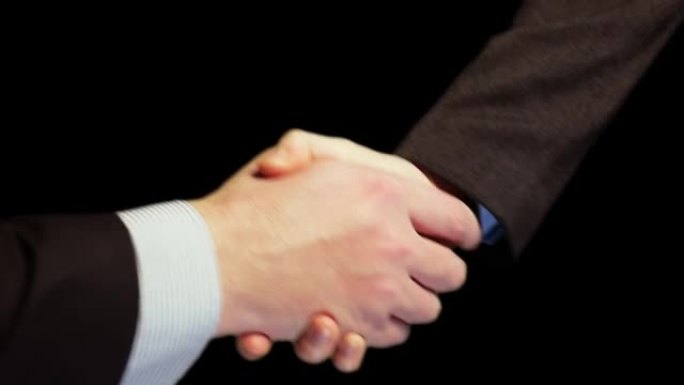 商人握手的特写。谈判成功后握手