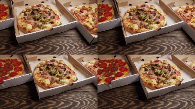 木制背景纸板箱中的意大利披萨套装