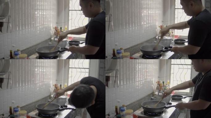 亚洲男人在厨房做饭。