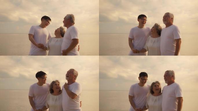 幸福亚洲家庭儿子和夫妇老人放松在日落海滩蜜月家庭一起跳舞幸福，人们的生活方式