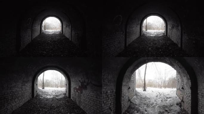 从树林中19世纪防御工事的旧废弃砖拱形隧道退出。