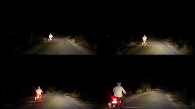在沥青路面上夜间行驶的4k镜头。司机在沥青路面上超越自行车人和汽车前灯。道路上的前照灯光束，配有极聚