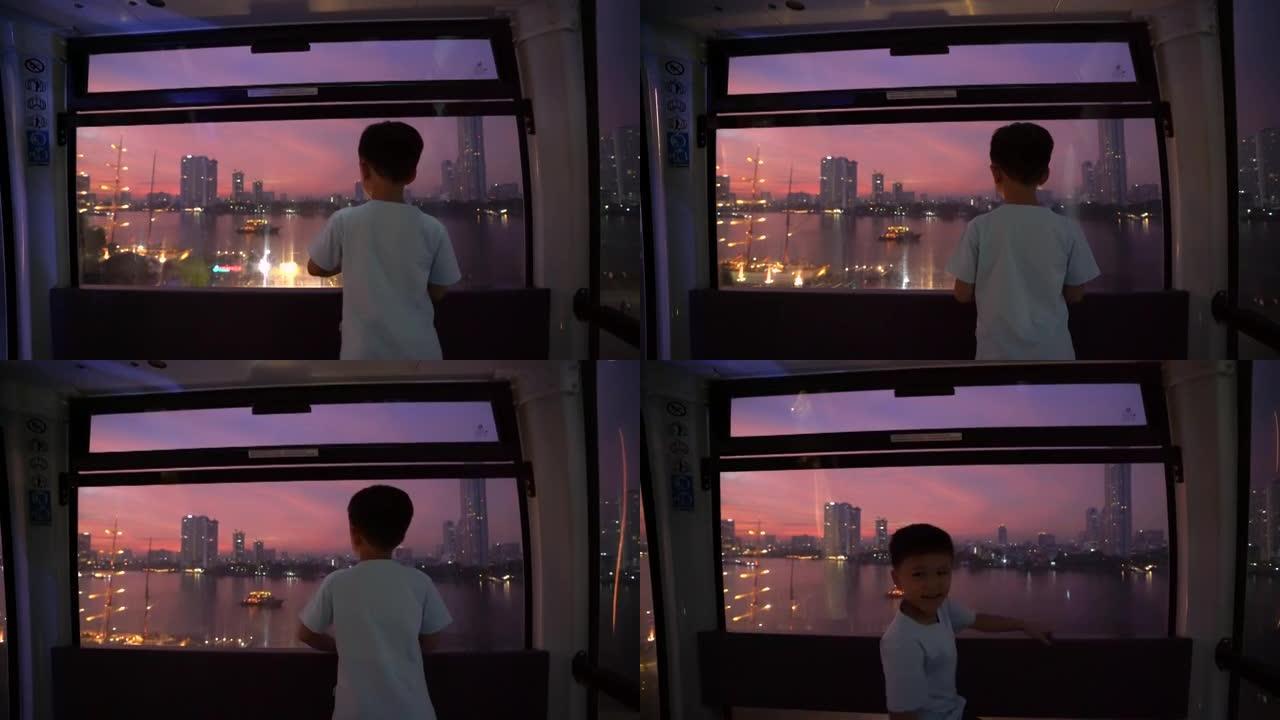 曼谷晚上摩天轮上的亚洲孩子。度假和梦想的概念