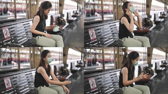 亚洲妇女使用酒精凝胶在进入曼谷曼谷火车站的火车前将手劈开泰国将在城市工作并戴上防护口罩，防止PM2.