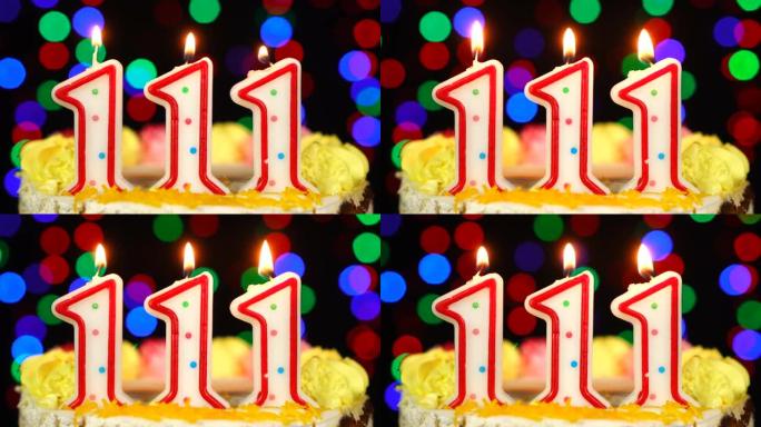 111号生日快乐蛋糕与燃烧的蜡烛顶。