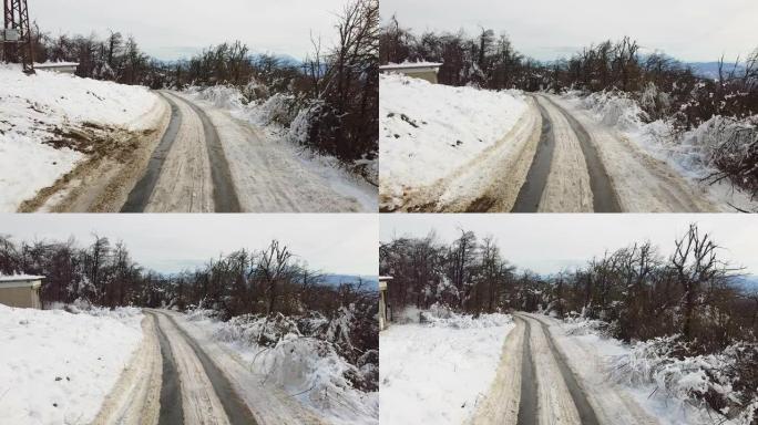 山上有雪和汽车轨道的街道。空中风景街，山上有雪和汽车轨道。鸟瞰图