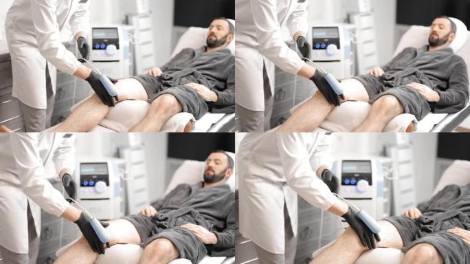 医生对男性膝盖进行磁疗