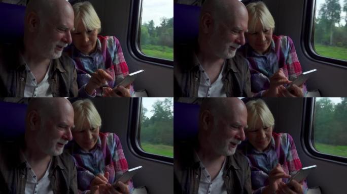 老年夫妇通过手机浏览地面地铁。高级男女在火车上交谈