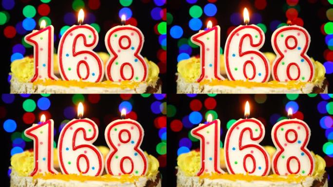 168号生日快乐蛋糕与燃烧的蜡烛顶。