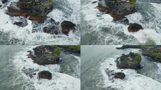 印度尼西亚巴厘岛的丹纳·洛特神庙 (Tanah Lot temple) 的危险岩石和强浪坠入海岸悬崖