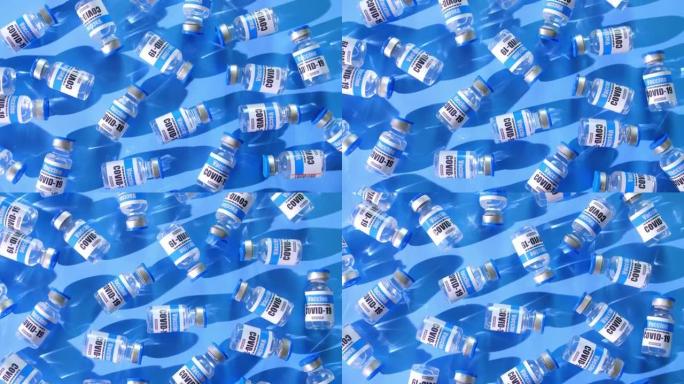 俯视图，玻璃小瓶新型冠状病毒肺炎疫苗在蓝色背景。一组冠状病毒的疫苗瓶。