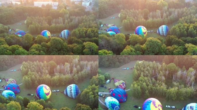 气球的美丽俯视图。夏天的早晨，气球飞过公园，城市。太阳的灯光。