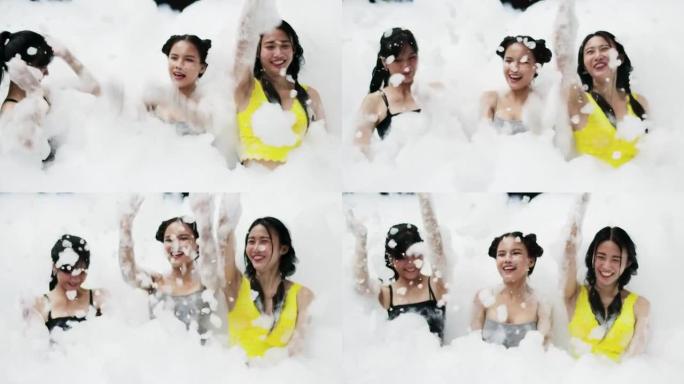 一群年轻女子在游泳池里玩泡沫和泡泡