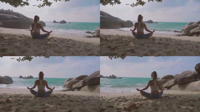 瑜伽姿势的女人沙滩女士背影