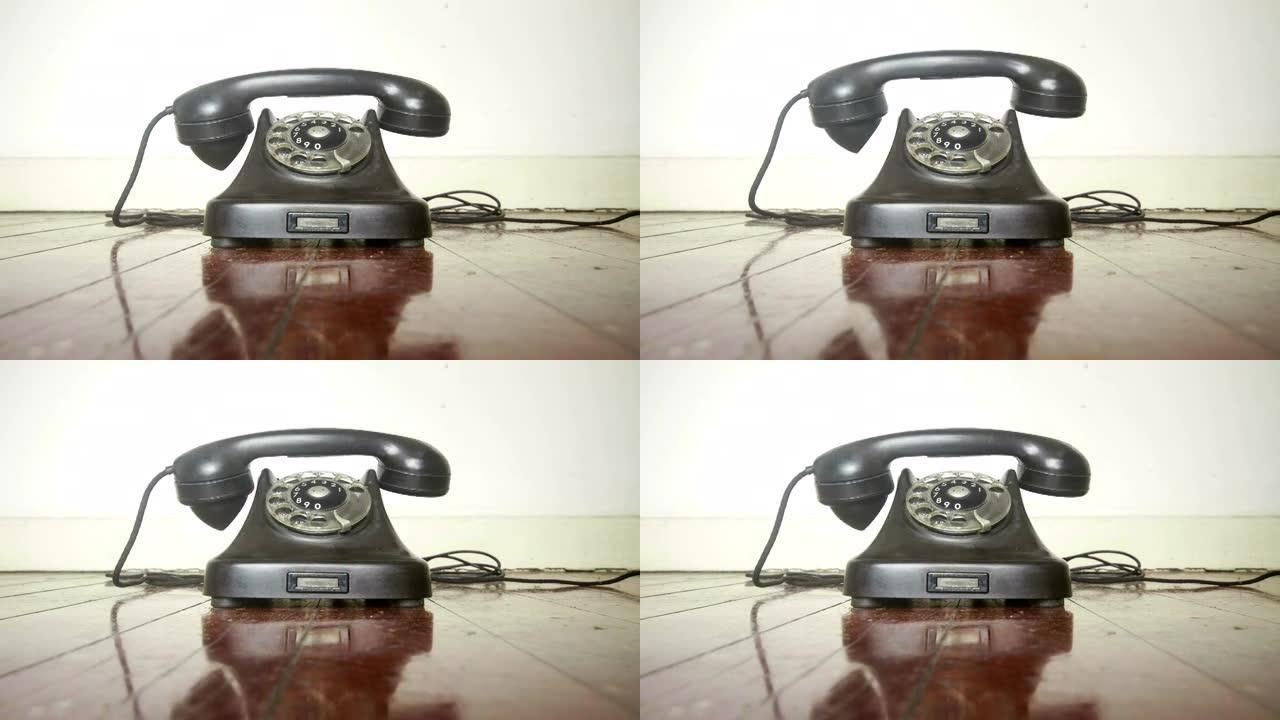 老式黑色电话在旧木地板上响起