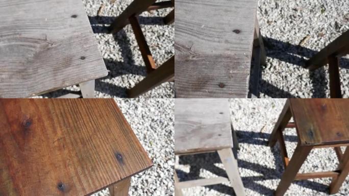 两个木凳之间的比较。一个是旧的，被毁的，另一个是用油和底漆处理和浸渍的。差异的特写
