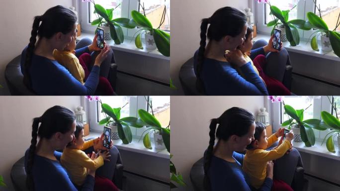 年轻女子和她在检疫的男婴进行视频通话