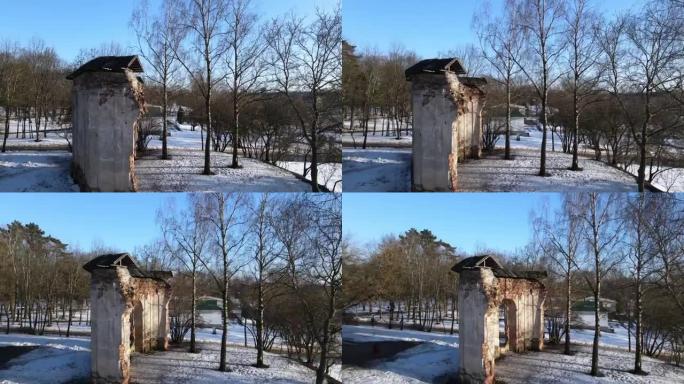 冬季公园的飞行。飞越旧建筑的废墟。无人机在废墟上飞来飞去。