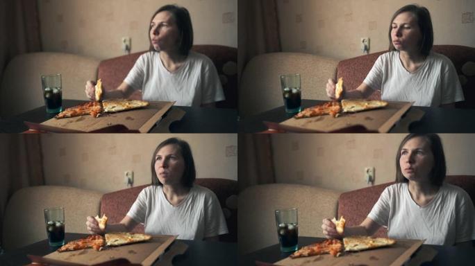 一个年轻女孩坐在家里的桌子旁，那里有一个大披萨