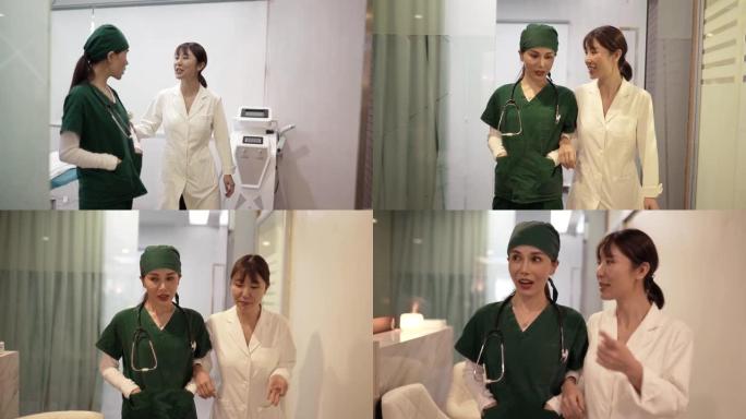 亚洲女医生和护士在医院走出手术室交谈。