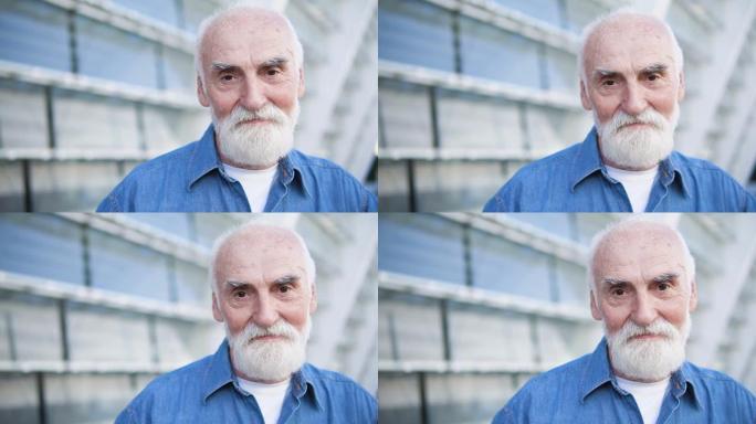 灰发男性养老金领取者看着相机，现代老人，退休