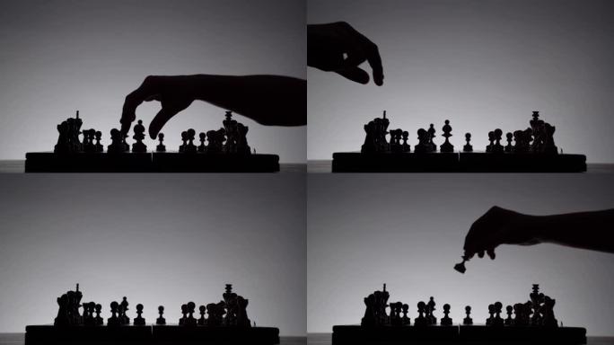 象棋游戏。白色背景上有棋子剪影的棋盘。经营理念和竞争与战略理念。黑白经典艺术照片。