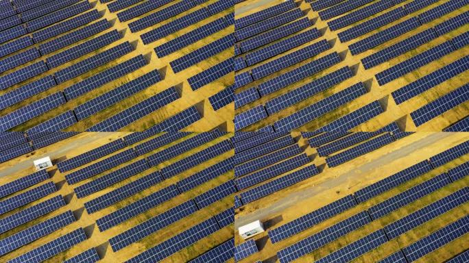 太阳能电池板农场的鸟瞰图，一排排的电池板从太阳中汲取能量