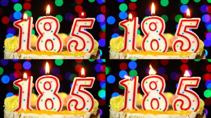 185号生日快乐蛋糕与燃烧的蜡烛顶。