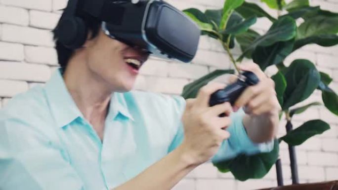 兴奋的帅哥戴着虚拟现实眼镜在家度假玩模拟游戏。