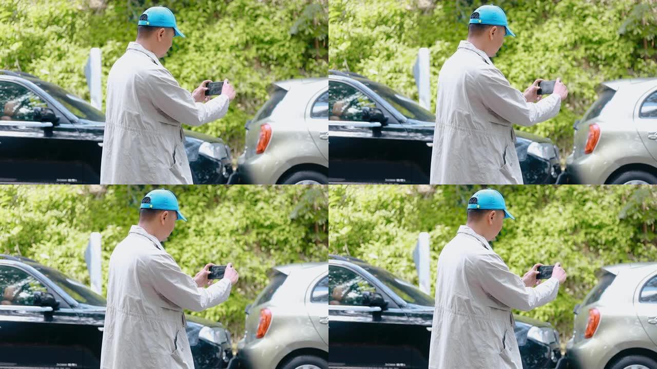 高清男子保险代理人通过智能手机拍摄车祸照片。车祸后两辆破车站在马路上