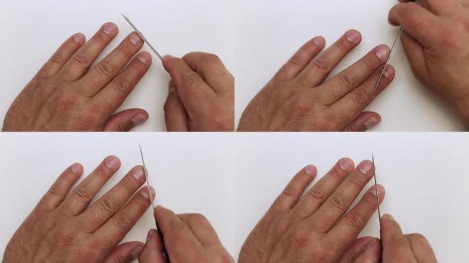 指甲锉的特写处理男人的手的中指。