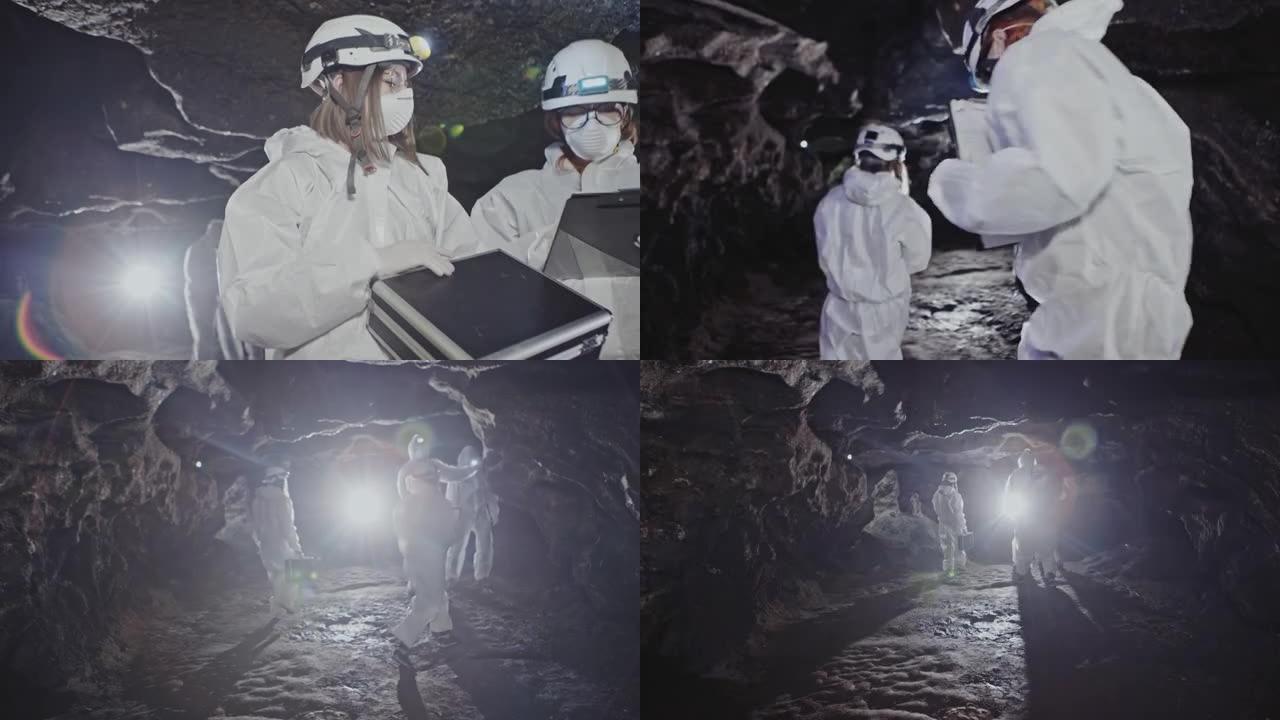 穿着白色防护服的科学家调查了神秘的洞穴
