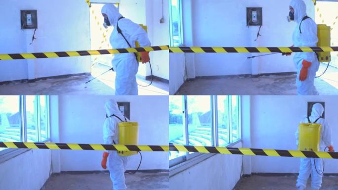 防护服中的科学家对住宅建筑空间进行消毒