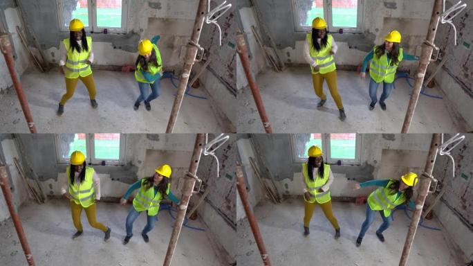 女性建筑工人在建筑物内的建筑工地跳舞