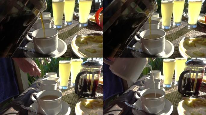 咖啡和牛奶洒在杯子里，背景是喝果汁，在热带度假胜地吃早餐