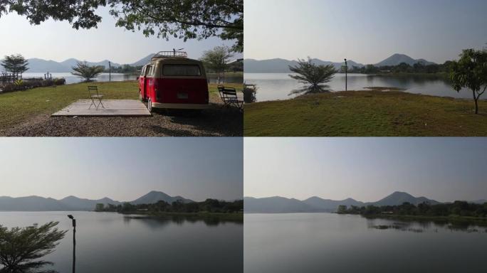 POV拍摄了穿过停在Lam Taphoen水库露营地湖边的复古露营车的镜头