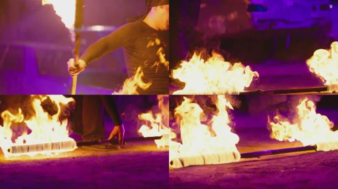 身穿黑色大手帕的成年男子表演凉爽而危险的消防表演，在夜间与双方分别点燃的消防警棍一起表演许多技巧。废